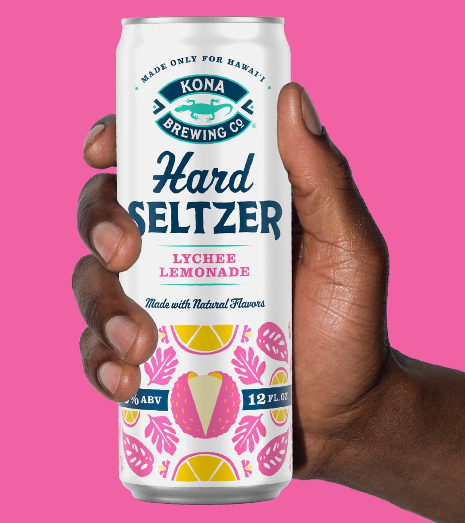 Kona Brewing Hard Seltzer Lychee Lemonade can held against pink background — packaging design by Kaleidoscope