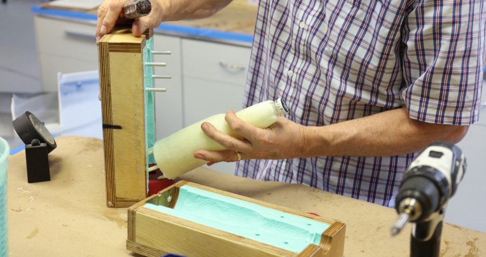 Packaging prototype being removed from mold in Kaleidoscope model shop, Chicago